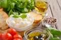 Italian food ingredients Ã¢â¬â mozzarella, tomatoes, basil and olive oil on rustic wooden background Royalty Free Stock Photo